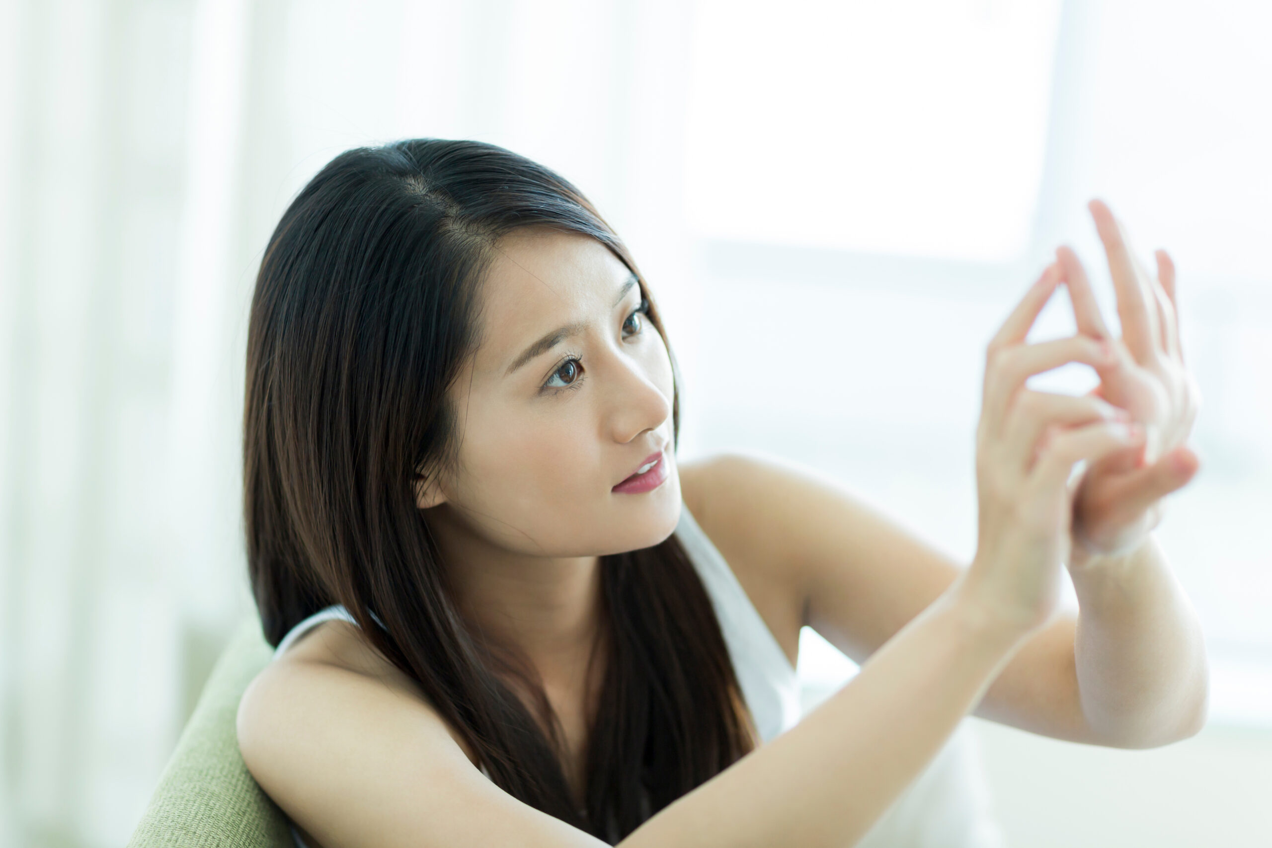 爪を気にしている女性